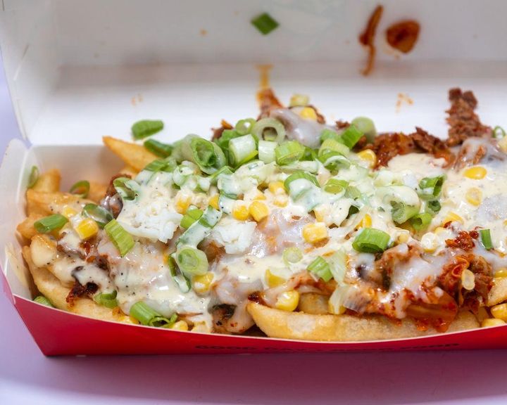 Chimac Kimchi Fries: Sautéed caramelized kimchi, with mozzarella cheese, steak, Corn, & Green Onions.